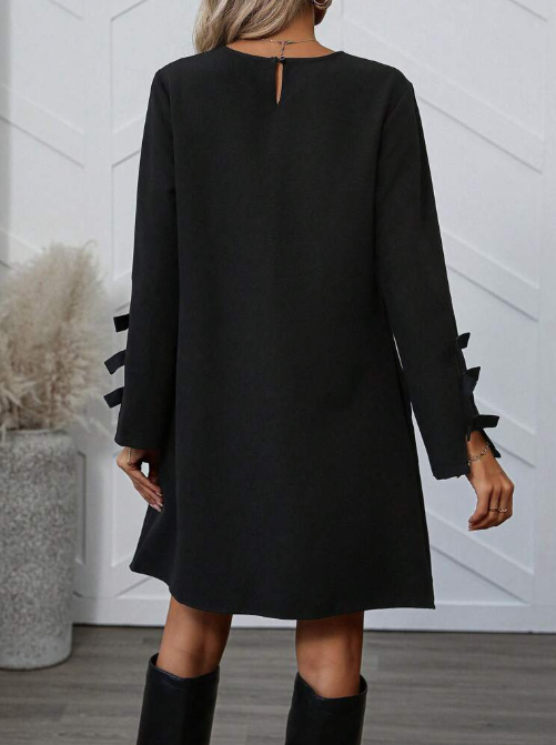 Dames zwarte a-lijn jurk – mini met elegante strikdetails