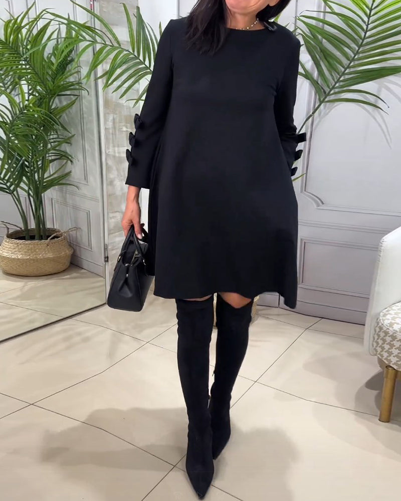 Dames zwarte a-lijn jurk – mini met elegante strikdetails